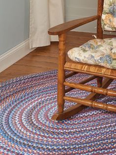 a wooden rocking chair sitting on top of a rug