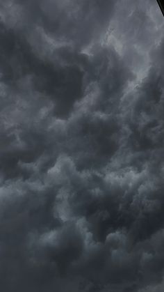 an airplane is flying in the cloudy sky