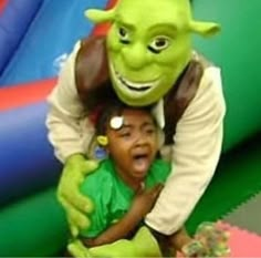 a young child is being hugged by an alien