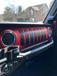 the interior of a car with red and black stripes on it's dash board