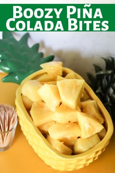 a bowl filled with sliced pineapples next to a pine cone on top of a table