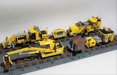 a lego train is shown with construction equipment on the tracks