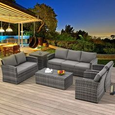 an outdoor living area with grey wicker furniture