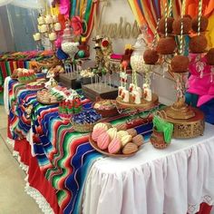 a table topped with lots of colorful desserts