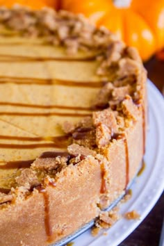 a close up of a cake on a plate with oranges in the back ground