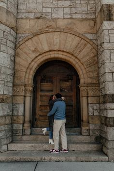 two people standing in front of a door