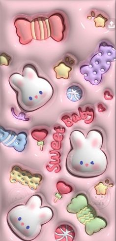 a pink background with many different types of candies