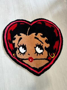 a heart shaped rug with an image of a woman's face on it