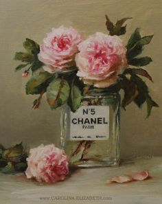 a painting of pink roses in a glass vase with chanel label on the front