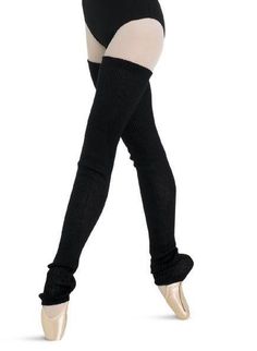 a woman in black and white tights is dancing