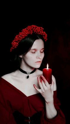 a woman holding a candle in her hands