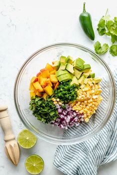 the ingredients for this mexican salad are neatly arranged in a glass bowl on a marble surface