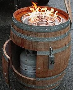 a wooden barrel with fire burning in it