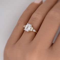 a woman's hand with an engagement ring on it, and the diamond is set in