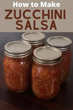 four jars filled with red sauce sitting on top of a wooden table next to the words, how to make zucchini salsa