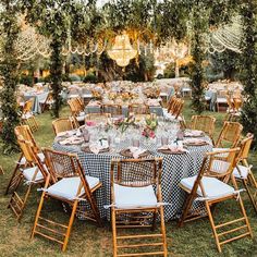 an outdoor table set up with chairs and tables covered in gingham cloths