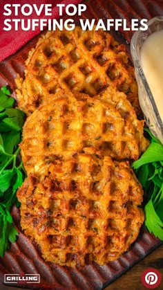 two waffles sitting on top of a wooden table next to some parsley