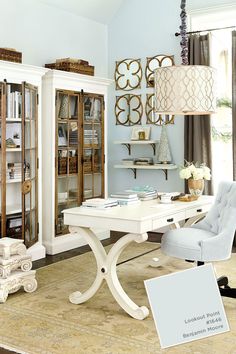 a white desk and chair in front of a bookcase with books on it's shelves