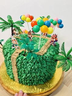 a cake decorated with green grass and palm trees