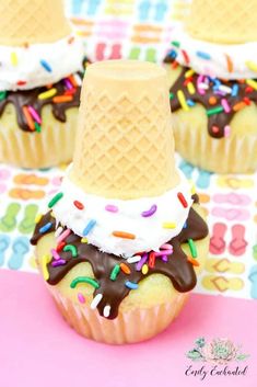 cupcakes with ice cream and sprinkles on top are sitting on a table