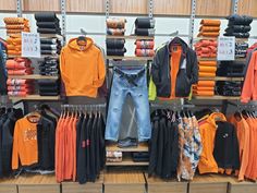 an assortment of men's clothing on display in a store