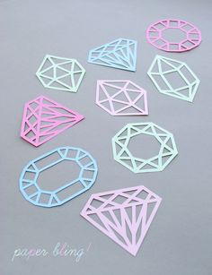 paper cut shapes are arranged on a gray surface