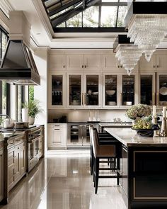 a large kitchen with an island and lots of counter space in the middle of it