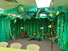 a room decorated with green paper streamers and chairs