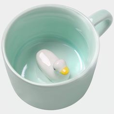 a rubber duck floating in a blue bowl