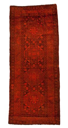 an old red rug with geometric design