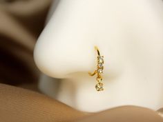 a close up view of a pair of earrings on a mannequin's head