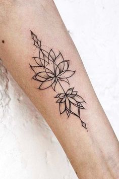 a woman's arm with a flower tattoo on the left side of her forearm