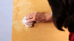 a woman wiping up the wall with a cloth on it's arm and hand