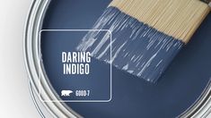 a paint can with the words daring indigo painted on it, and a brush inside