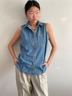 Vintage Bill Blass faded denim sleeveless blouse featuring branded riveted metal buttons, relaxed fit, breast pockets, and shirttail hem.   Bust 42 Waist 43 Hips 44 Length 29  90s Bill Blass Jeans. 100% Cotton Tagged size M Excellent vintage condition. Model is 5'10 size 2/4  Large Bill Blass Jeans, Bill Blass, Faded Denim, Metal Buttons, Designer Outfits Woman, Sleeveless Blouse, Shirt Outfit, Chambray, Womens Clothing Tops