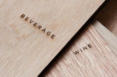 two wooden boxes with the words beverage and wine engraved on them sitting next to each other