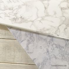 two pieces of white marble sitting on top of each other next to eachother