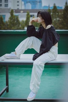 a woman sitting on top of a bench in front of a cityscape with the caption ace factory