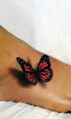 a woman's foot with a butterfly tattoo on it