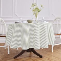 a dining room table covered with a green and white striped cloth