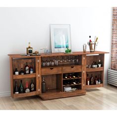 a wooden cabinet filled with bottles and glasses