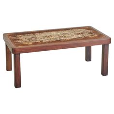 a wooden table with an intricate design on the top and bottom, sitting against a white background