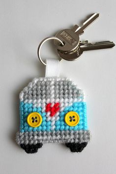 a crocheted keychain with a blue and white car on it