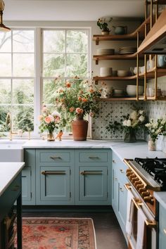 a kitchen filled with lots of counter top space next to a stove top oven and sink