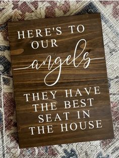 a wooden sign that says here's to our angels they have the best seat in the house