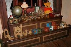 there is a wooden toy display on the table with other toys in front of it