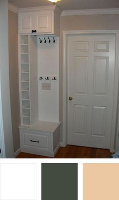 an entryway with white cabinets and drawers