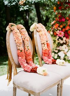 two chairs decorated with flowers and ribbons