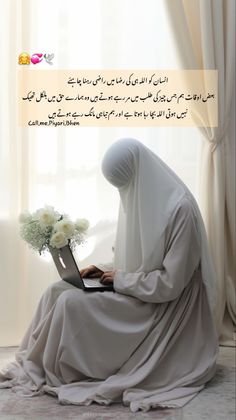 a woman sitting in front of a laptop computer on top of a table next to a window