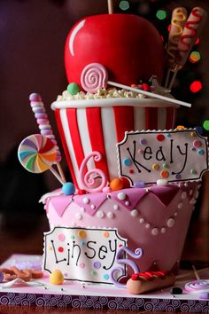 there is a cake made to look like a popcorn bucket with candy and an apple on top